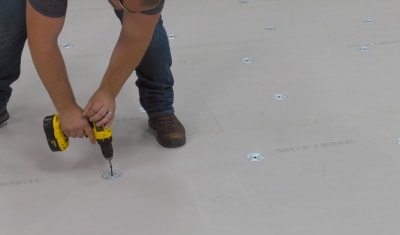 roofer installing polyiso roofing insulation