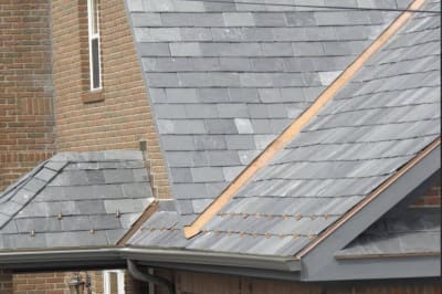 Cooper flashing in the roof valley of a slate roof