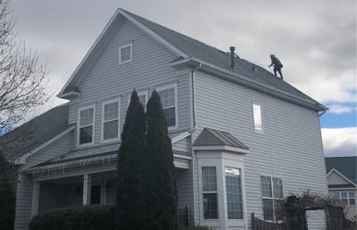 Roofsimple worker installing new roofing system for Timothy Hardman