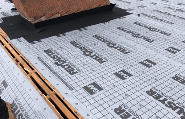 Roofsimple working on roof installing new roofing system for Mary Baldwin