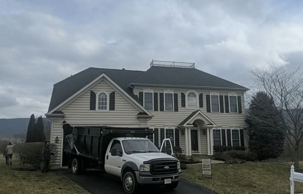 Roofsimple workers on roof installing new roofing system for Paul Blacet