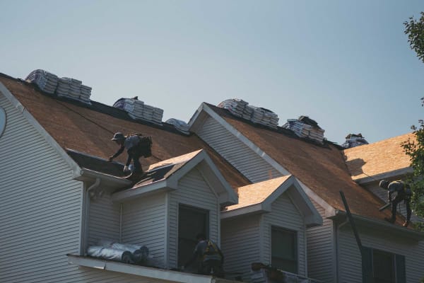 Roofsimple worker on roof installing new roofing system