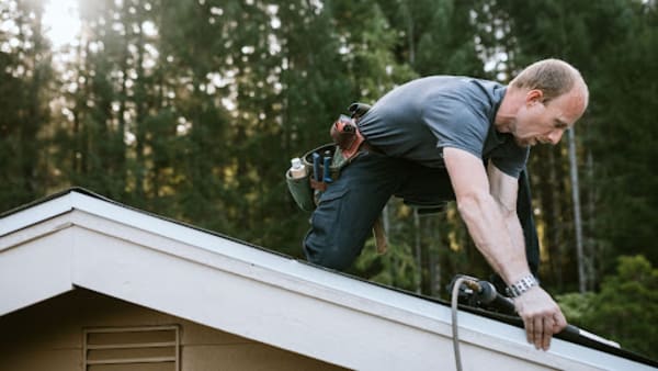 Roofer repairing a roof