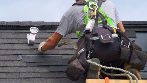 Roofing contractor installing shingles