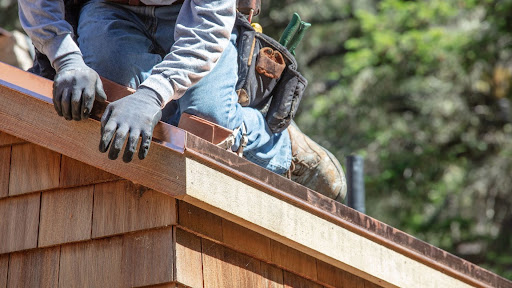 Roofing contractor installing shingles
