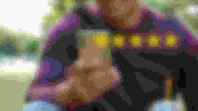Man looking at his cell phone smiling with a 5 star graphic positioned in front