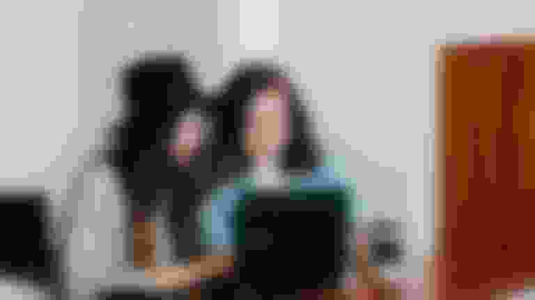 two women looking at laptop