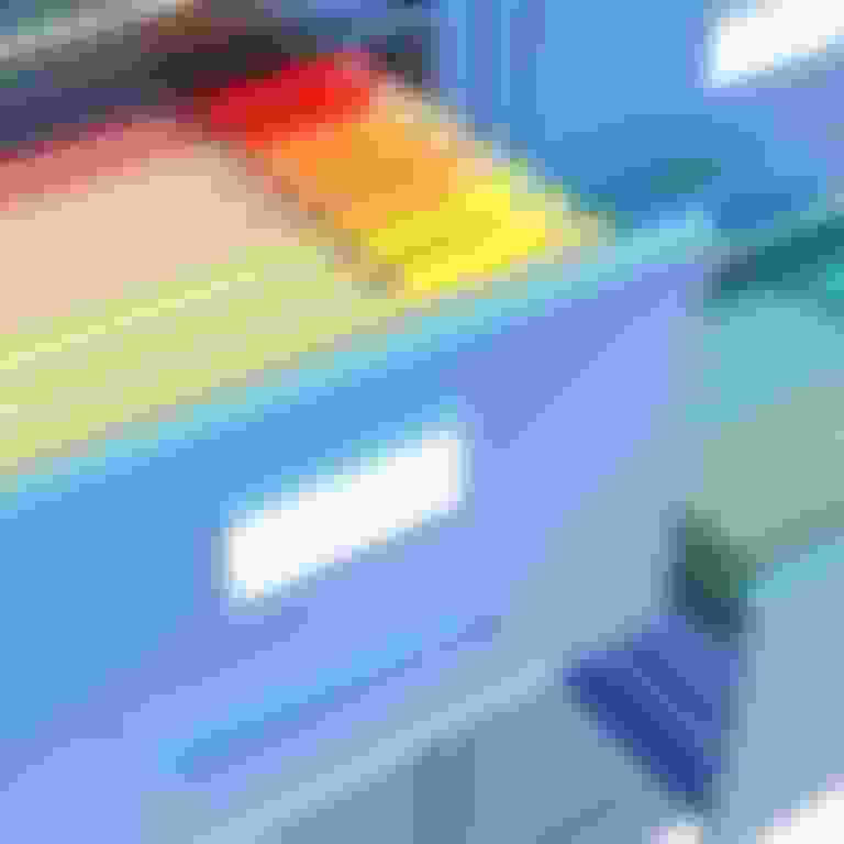 File cabinet drawer open with bright colored files inside.