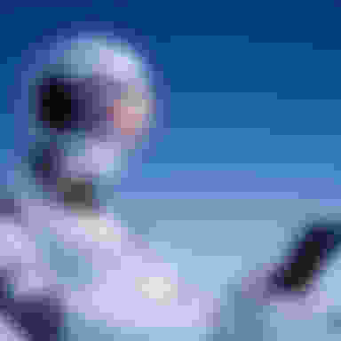 Robot looking at a cellphone.