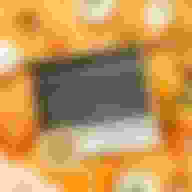 laptop on fall background with pumpkins