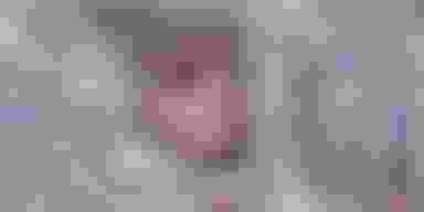 childs face peering through a pile of cash