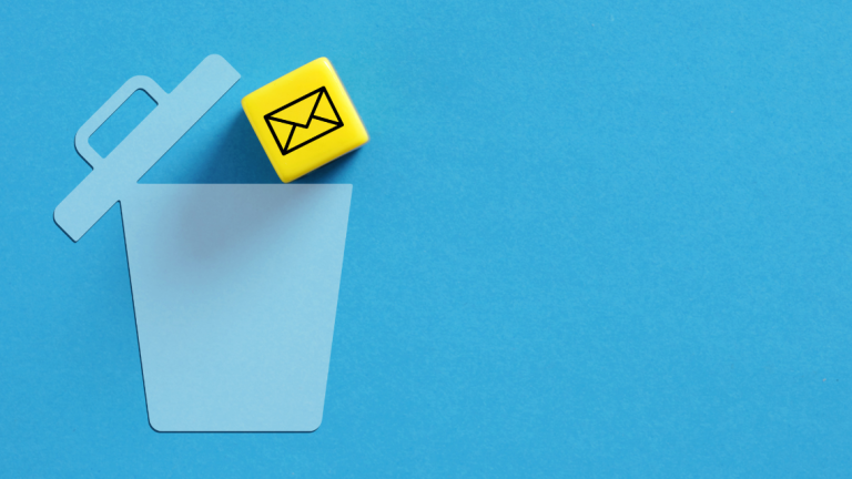 A paper cut out of a trashcan with a tile representing email being tossed into it.