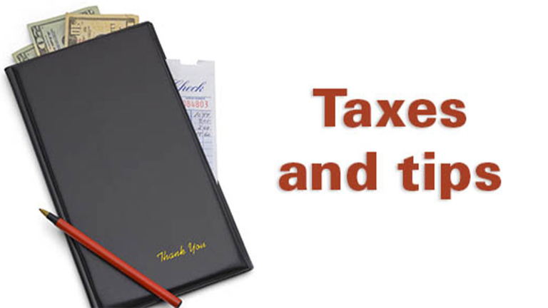 A receipt book with money stick out of the top an a pen resting on it.