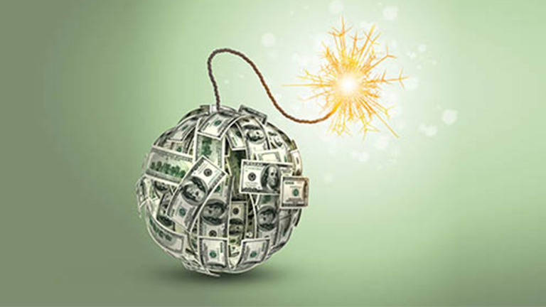 A ball of money with a wick sticking out of it that is lit at the end.