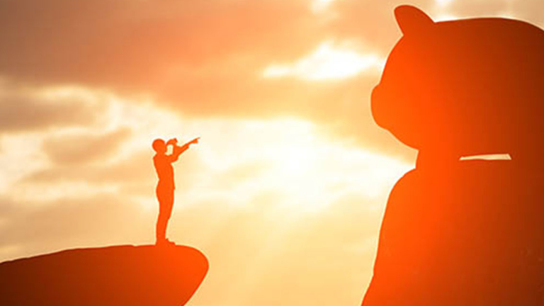 A man with binoculars looking at a giant piggy bank.