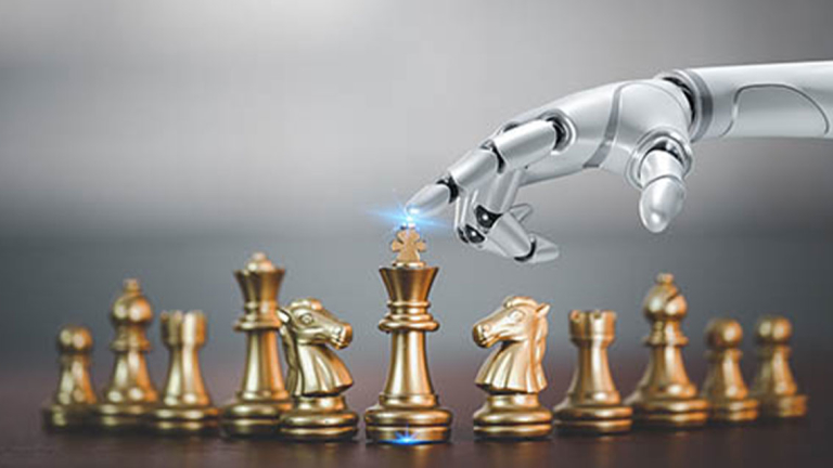 A robotic hand with it's finger on a King chess piece.