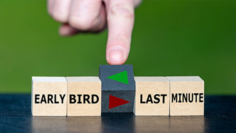 A finger rotating the middle block of 5 wooden blocks.