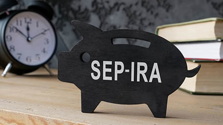 A cutout of a pig on a desk with an alarm clock and books.