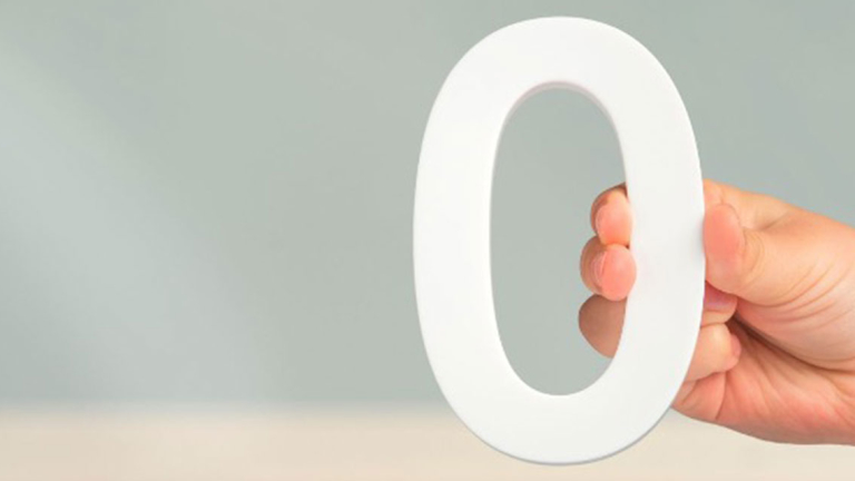 A hand holding a zero.