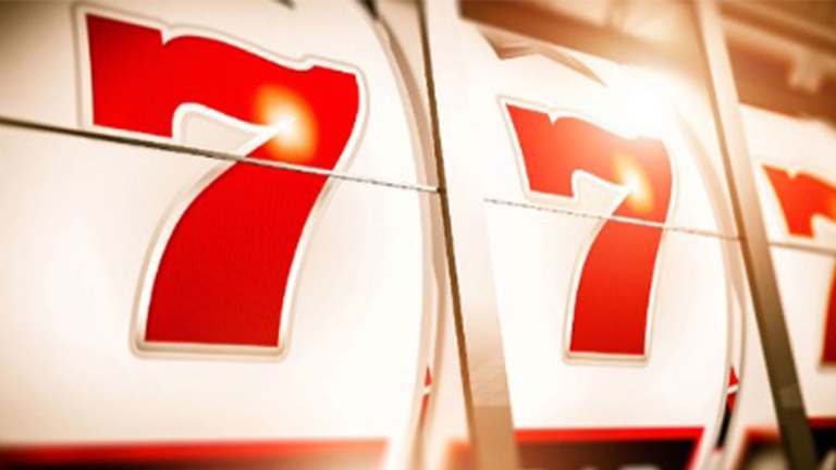 Slot machine showing all 7's.