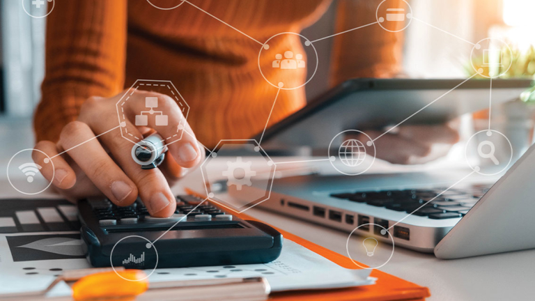 Woman holding a tablet and using a calculator.