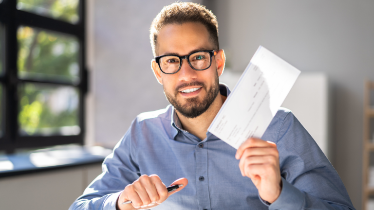Payroll check being held by man