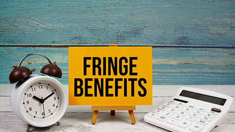 clock and calculator with sign 'fringe benefits' printed