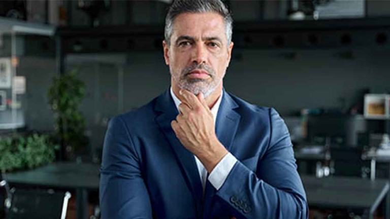 business man with hand under chin in a thoughtful pose