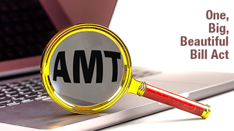 A magnifying glass resting on an open laptop.