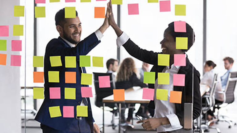 Business professionals high-fiving.