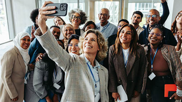Group of business professionals taking a selfie.