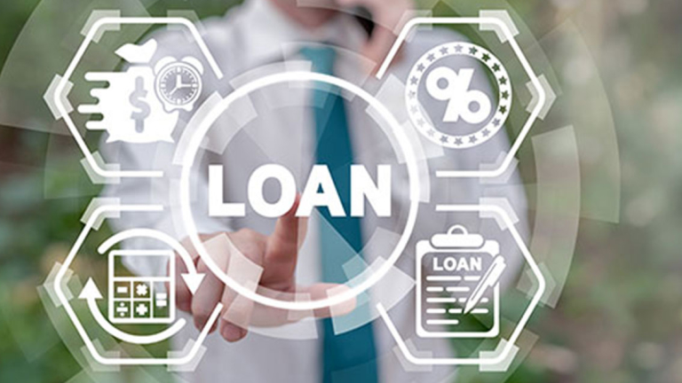 A businessman on a mobile phone pushing a button that says loan.