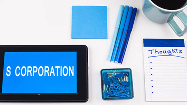 Tablet, sticky notes, mug, pens, notebook and paperclips.