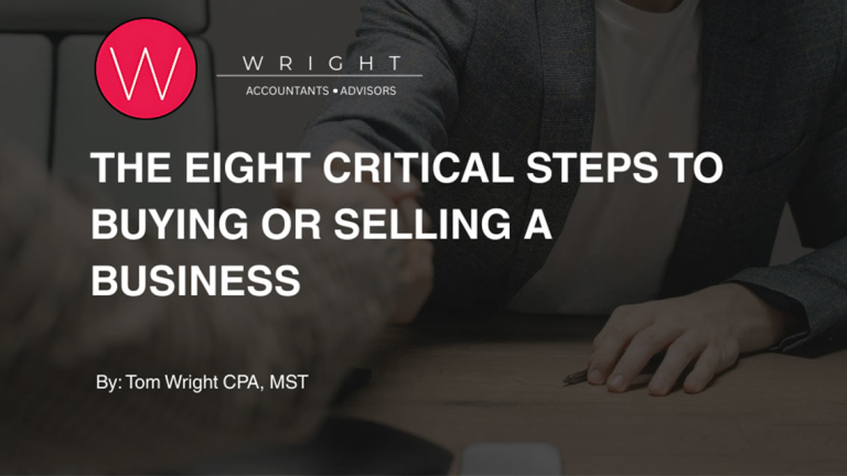 People at a table shaking hands.