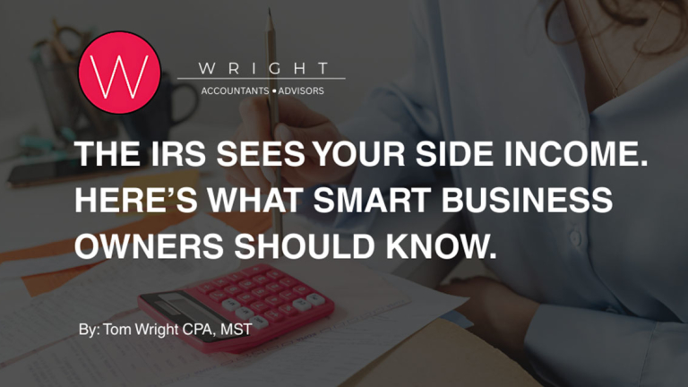 A woman at a desk with a calculator, papers and holding a pencil.