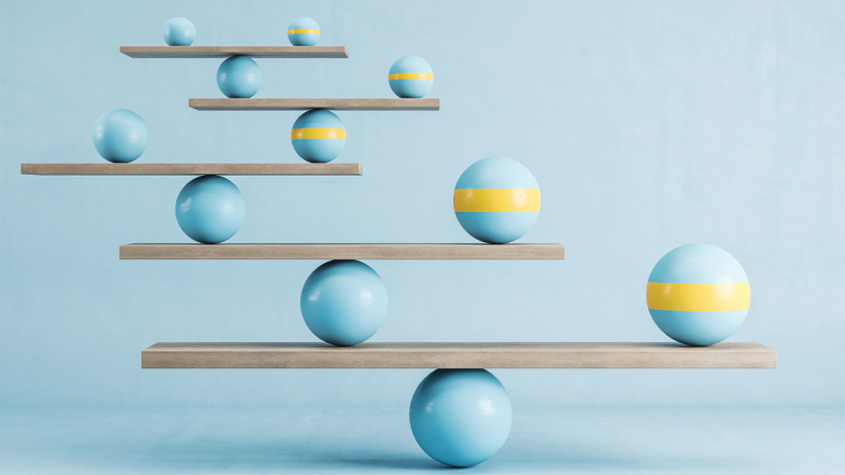 Balls balanced on pieces of wood.