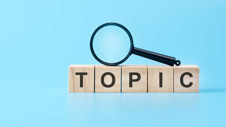 A magnifying glass resting on top of wooden blocks.