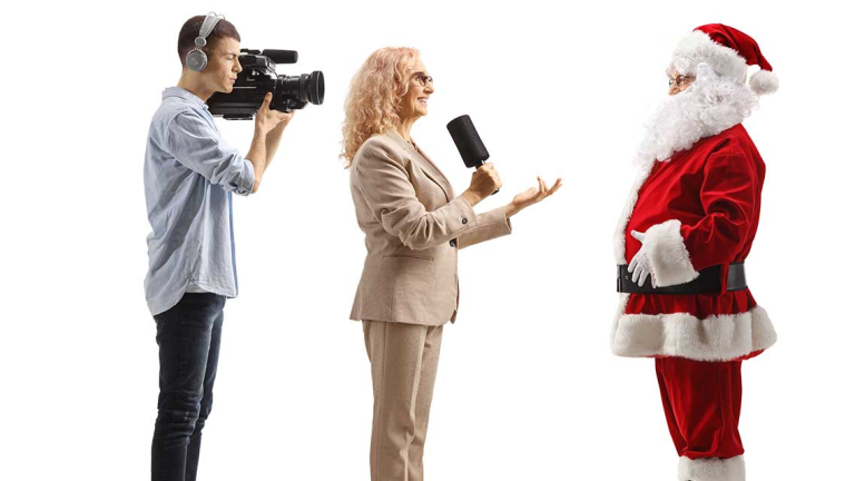 Santa talking to a reporter and cameraman.