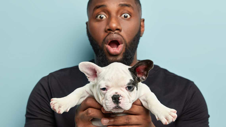 Man holding a puppy