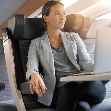Young businesswoman working in first class on a train