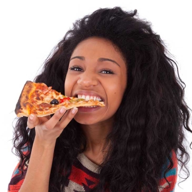 female eating a slice of pizza
