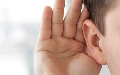 Hand cupped over ear.