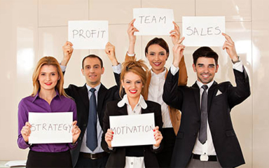 Business professionals holding up motivational signs.