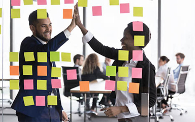 Business professionals high-fiving.