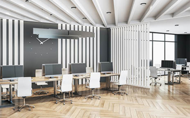 Office with desks, chairs and computer monitors.