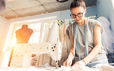 A woman using a sewing machine.