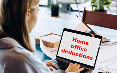 A woman using a laptop at a table.