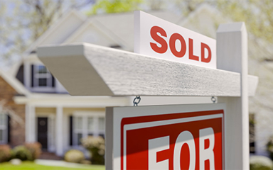 A home For Sale sign.