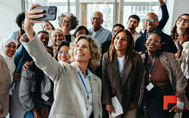 Group of business professionals taking a selfie.
