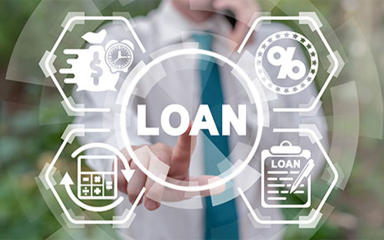 A businessman on a mobile phone pushing a button that says loan.